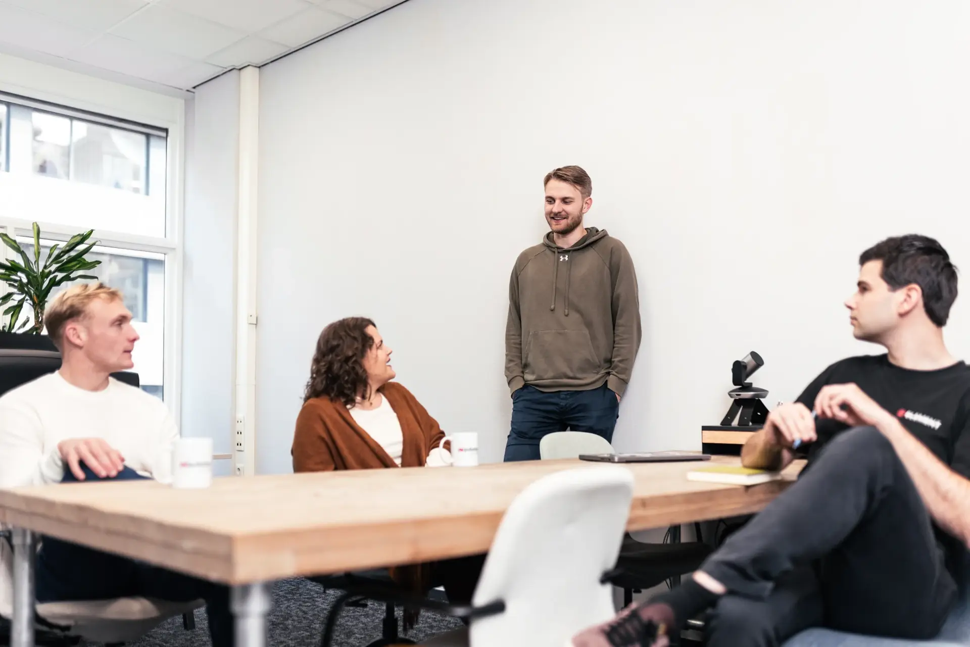 Four people in conversation around a table at Inqubator
